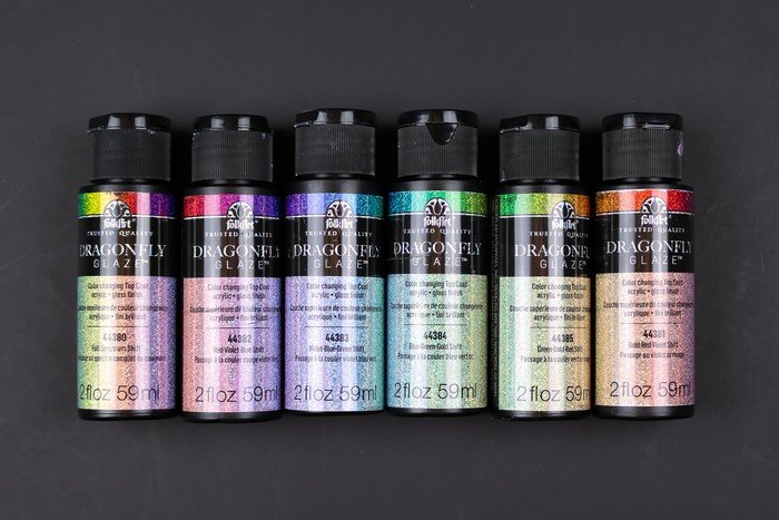 bottles of FolkArt Dragonfly Glaze arranged in rainbow order