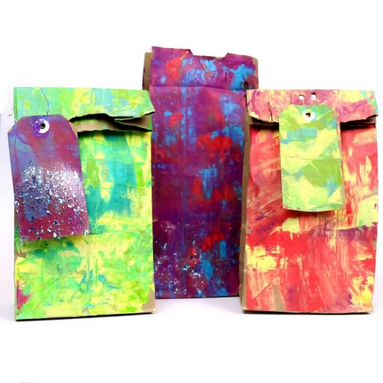 colorfully painted gift bags on a white background