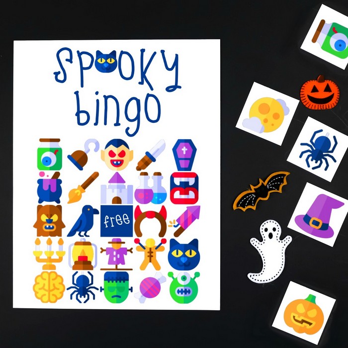 printable halloween bingo cards, tiles, and scissors on a black background