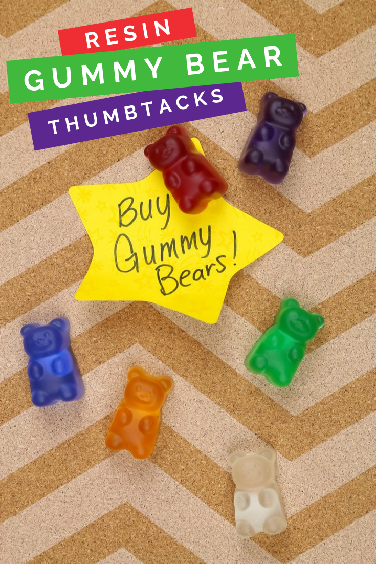 colorful resin gummy bear thumbtacks on a cork board