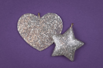 silver glitter resin ornaments on a purple background