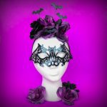 DIY halloween bat accessories on a foam head on a purple background