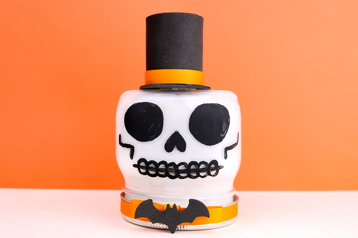 skull painted mason jar on an orange background
