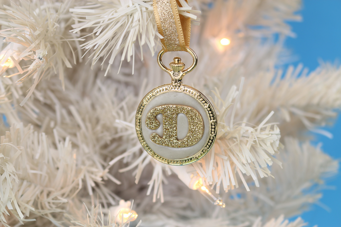 DIY Gold monogram ornament hanging on a white tree
