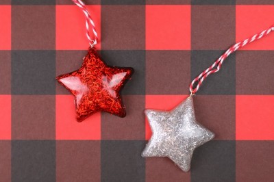 glittery star ornaments on a red buffalo check background