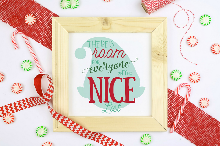 elf quote printable in a wood frame with ribbons and candies