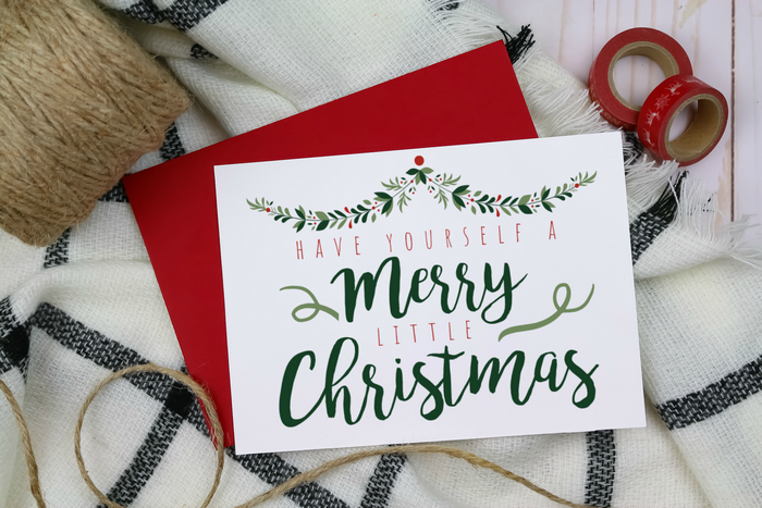 Farmhouse style Christmas card on a red envelope with twine and washi tape