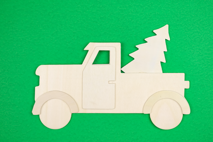 unpainted wood truck sign on a green background