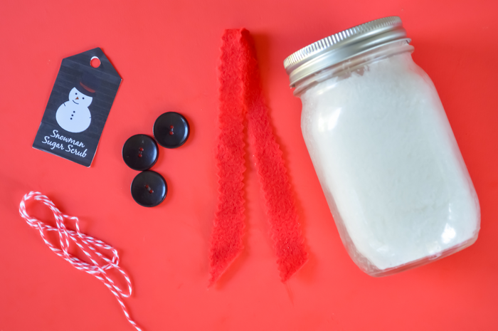 mason jar and craft supplies on a red background