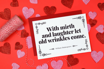Shakespeare Valentine card with red envelope next to baker's twin and glitter hearts