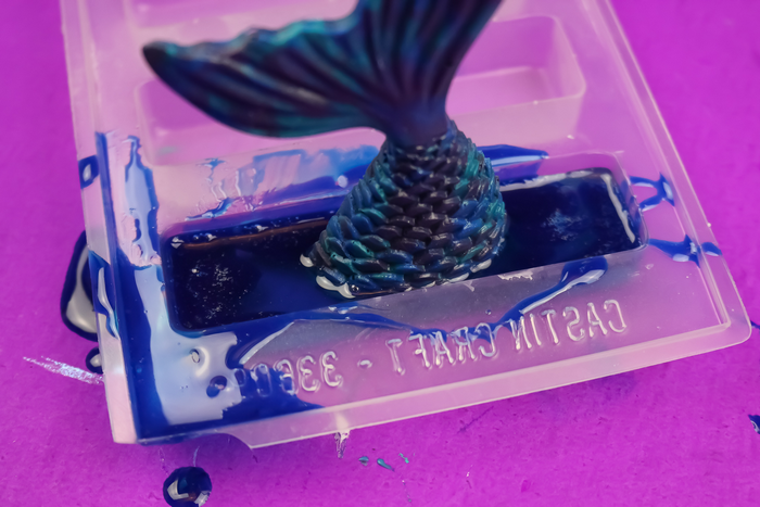 Blue resin mermaid tail in a resin drawer pull mold