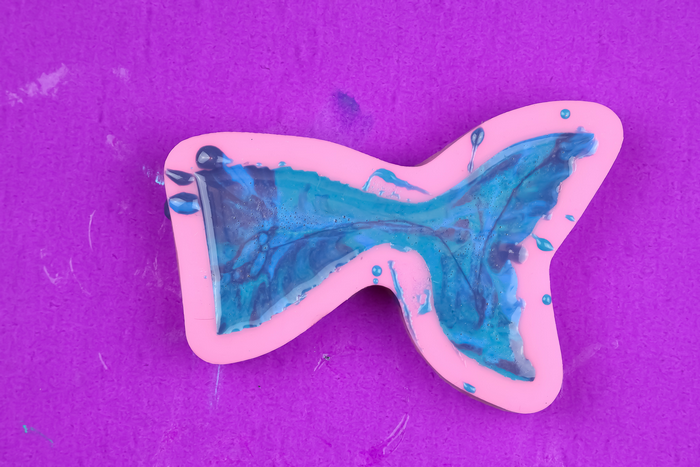 blue resin swirled in a silicone mermaid tail mold