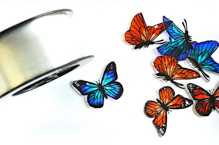 blue and orange shrink plastic butterflies and monofilament