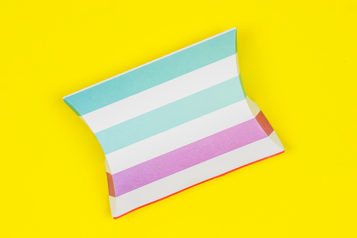 colorful pillow favor box on a yellow background