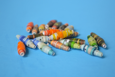closeup of rolled paper beads on a blue background