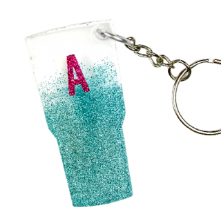 close up of a glitter tumbler key chain with a pink A