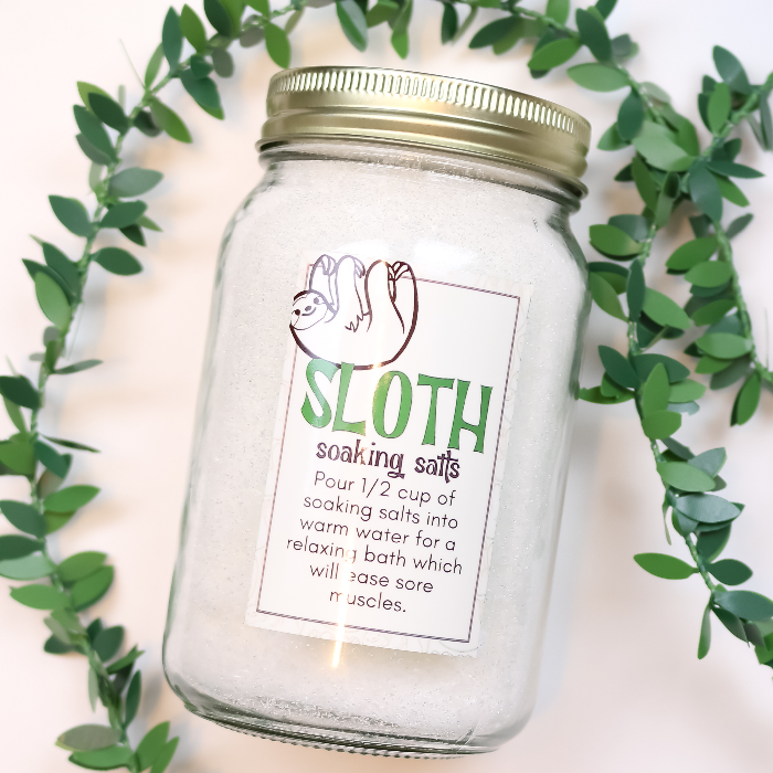  a mason jar of DIY bath salts with a printable sloth label with green vines