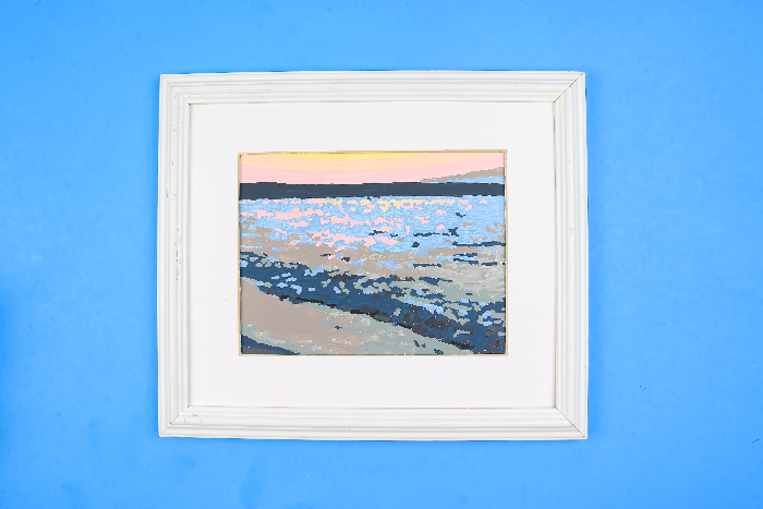 paint by number painting in a white frame on a blue background