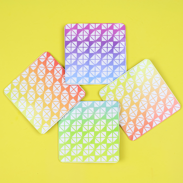 Colorful Infusible Ink coasters on a yellow background