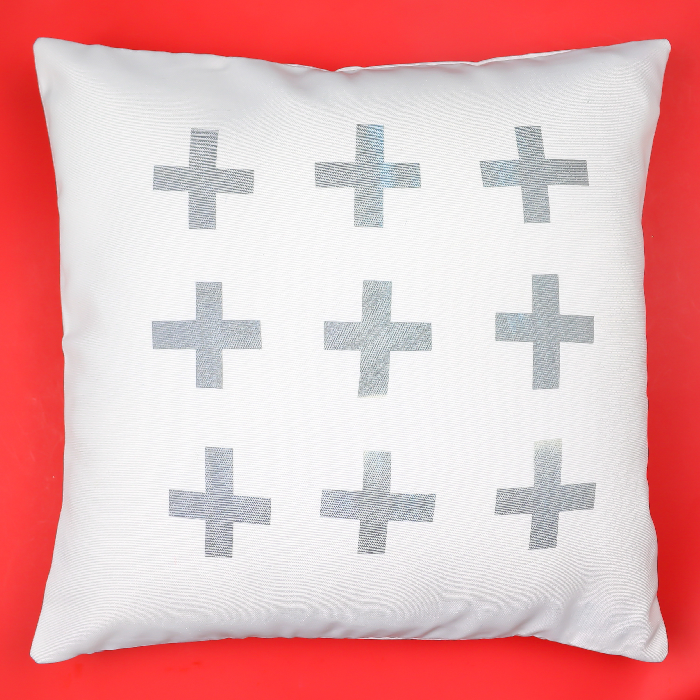Grey and white Infusible ink throw pillow on a red background