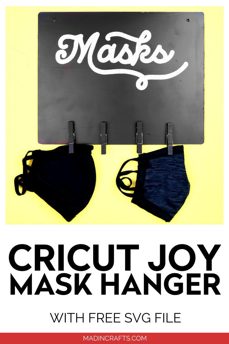 Black mask sign with hooks on a yellow background with masks