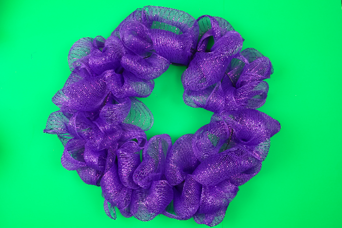 purple mesh wreath on a green background