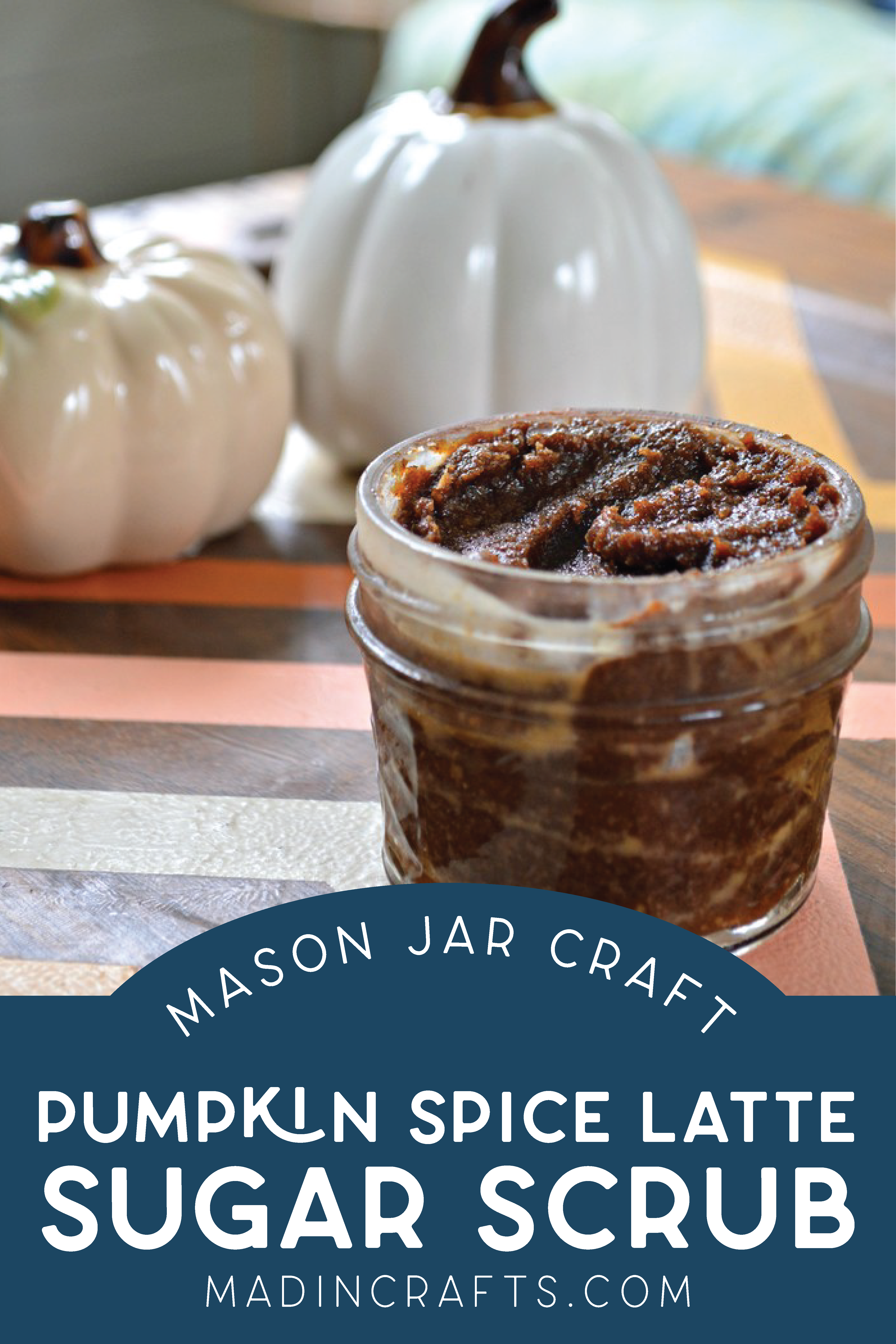 Mason jar of pumpkin spice latte sugar scrub on a table with a ceramic pumpkin