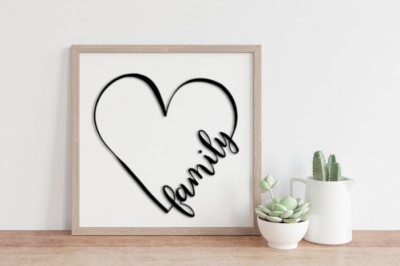 Family heart SVG design in a wood frame next to succulents