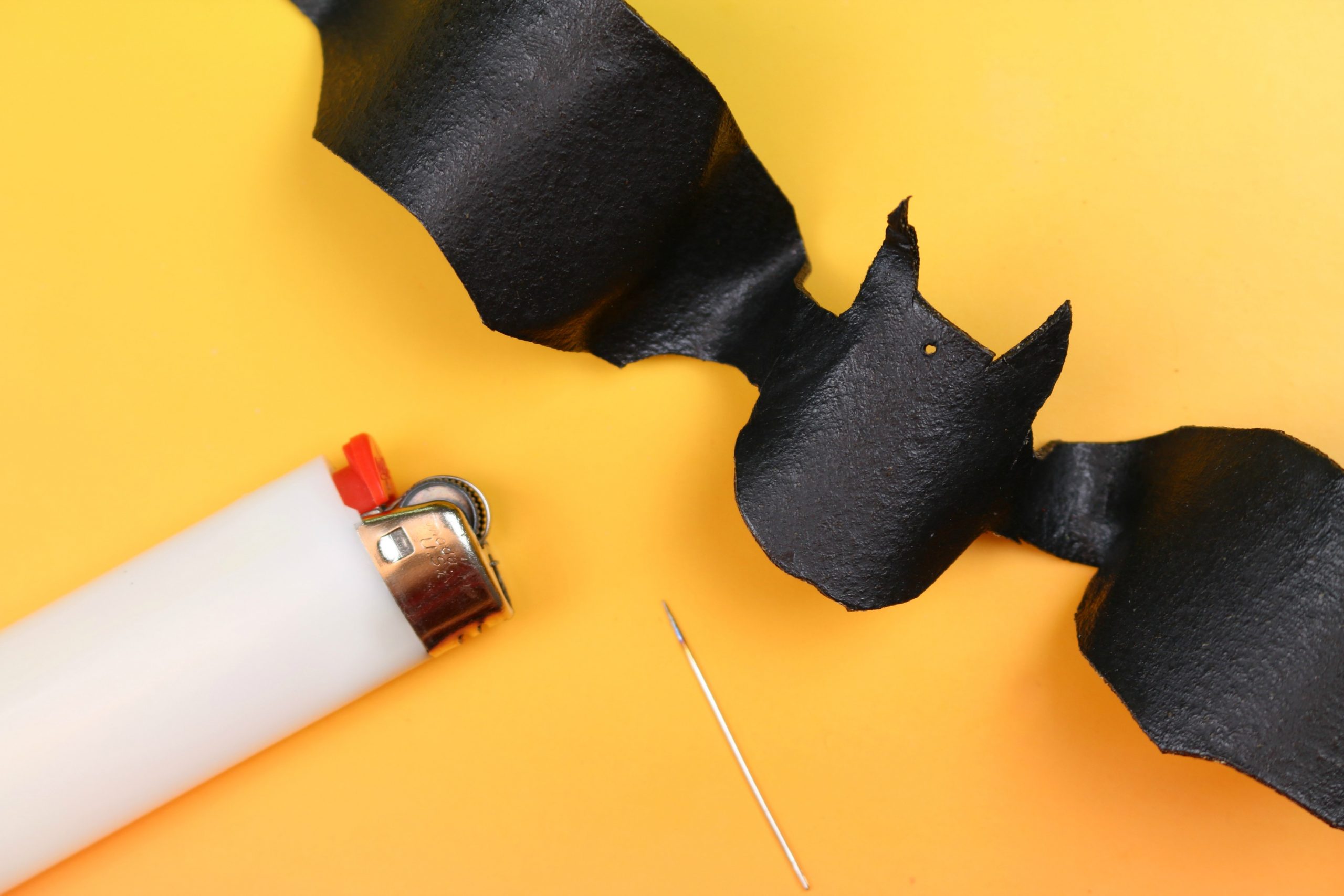 black bat shape cut out of worbla plastic with lighter