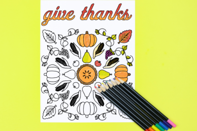 Give thanks coloring page with colored pencils on a yellow background