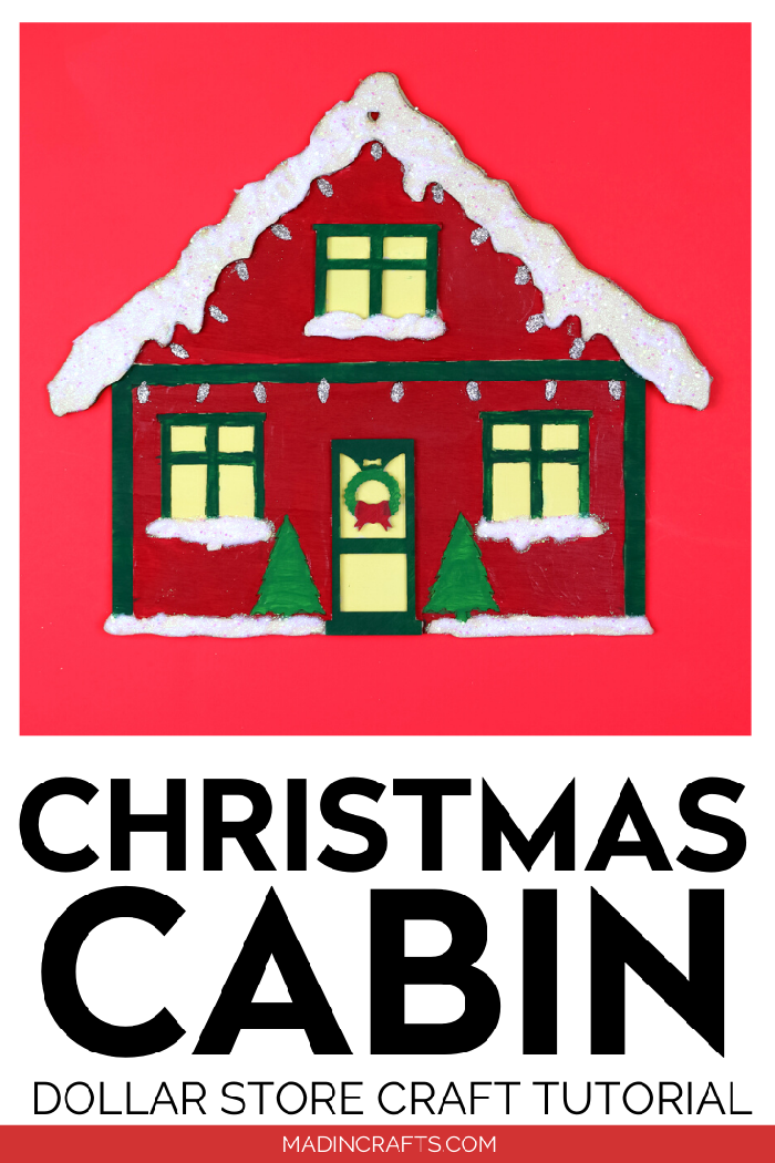 Painted Christmas house sign on a red background