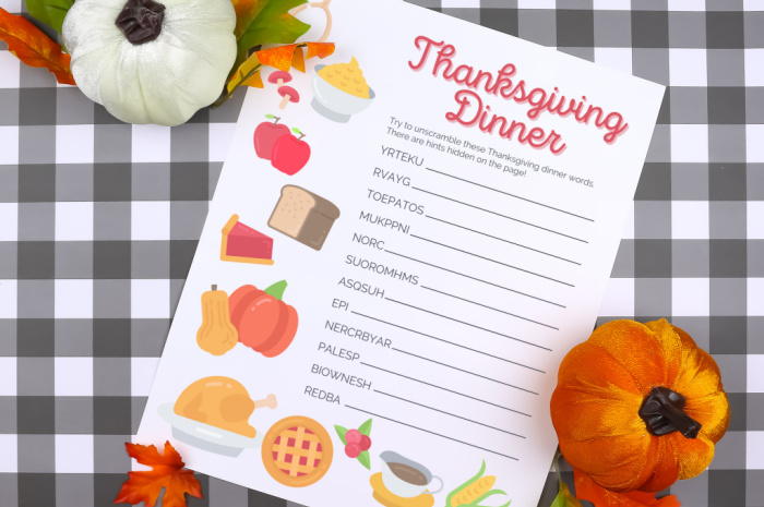Thanksgiving word scramble printable on a plaid background with pumpkins