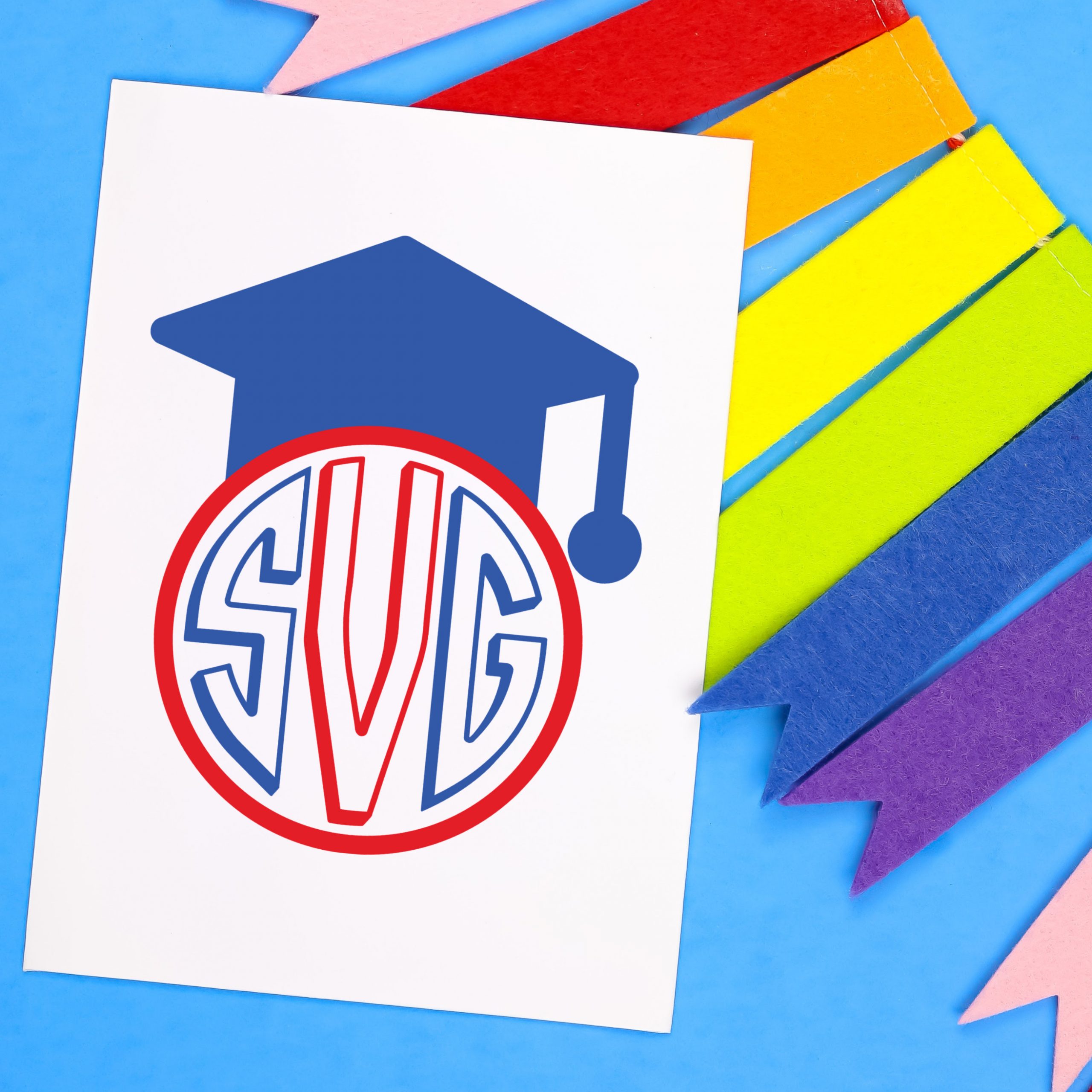 Colorful bunting and white card with a blue and red graduation monogram
