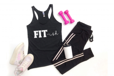 A flat lay of black workout gear with a design that says FIT-ish