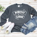 grey sweatshirt with Perfect is Boring SVG file near shoes and jeans