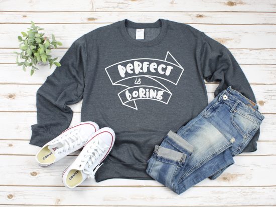 grey sweatshirt with Perfect is Boring SVG file near shoes and jeans