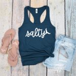 navy blue tank with Salty SVG next to flip flops and shorts