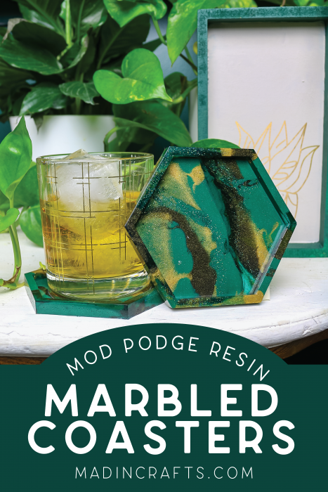 Marbled coasters and a glass of whiskey on a table