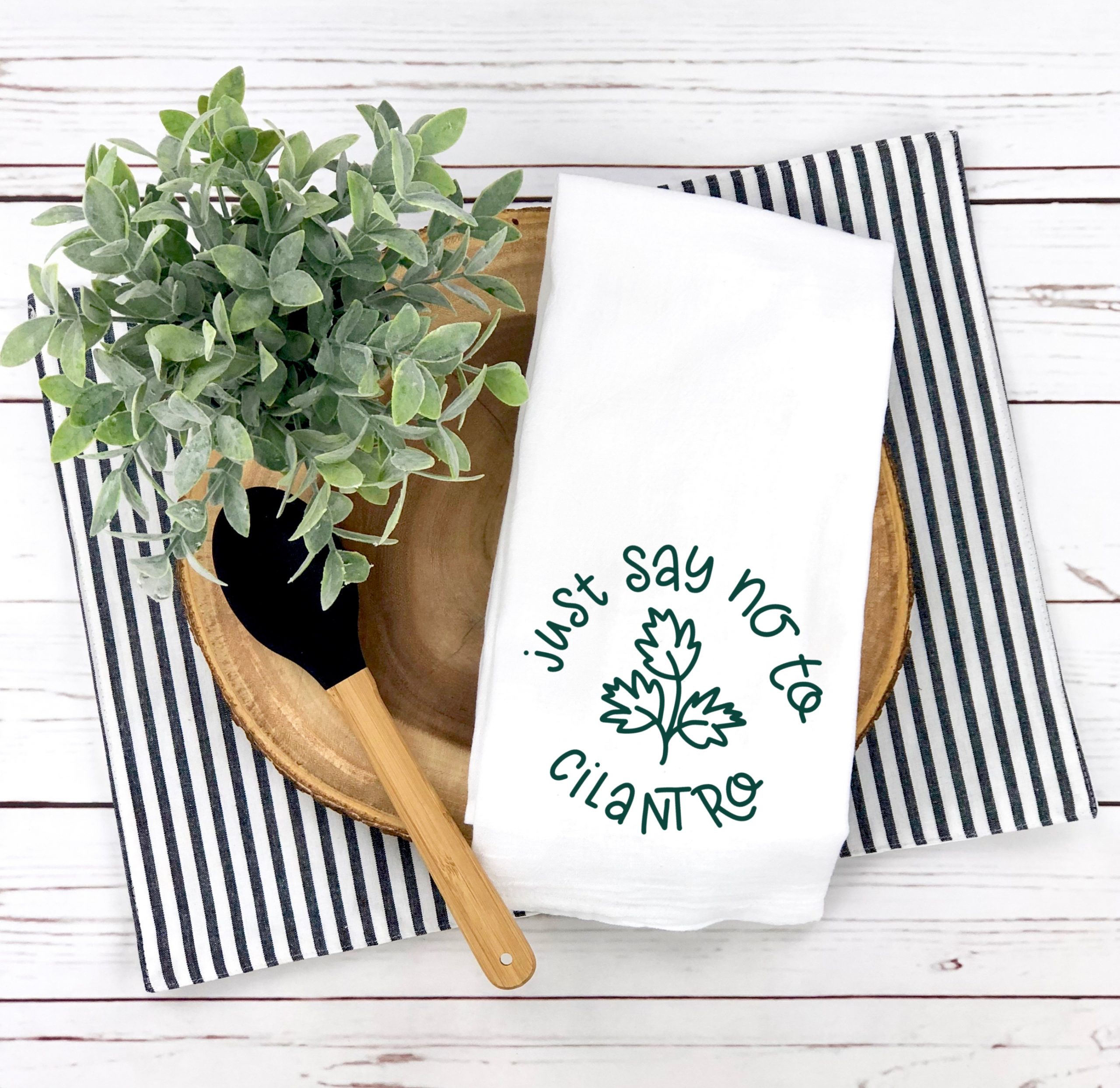 white "just say no to cilantro" kitchen towel with placemat and bowl