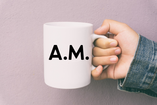 hand holding coffee mug with AM SVG design