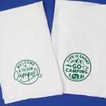 two tea towels with camping designs in green vinyl
