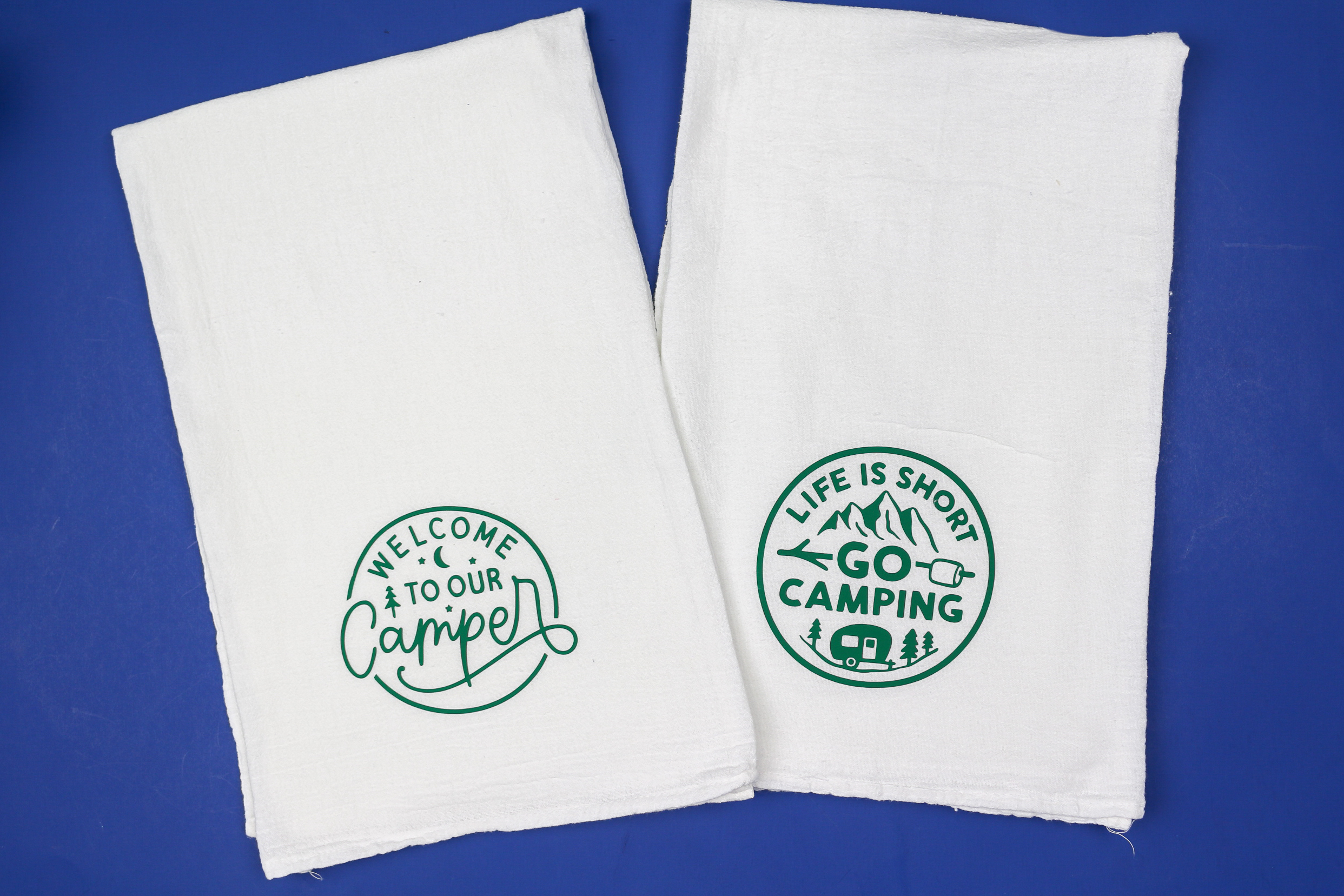two tea towels with camping designs in green vinyl