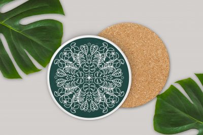 circular coasters with plant svg designs near monsterra leaves