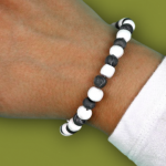 woman's wrist wearing black and white bug repelling bead bracelet