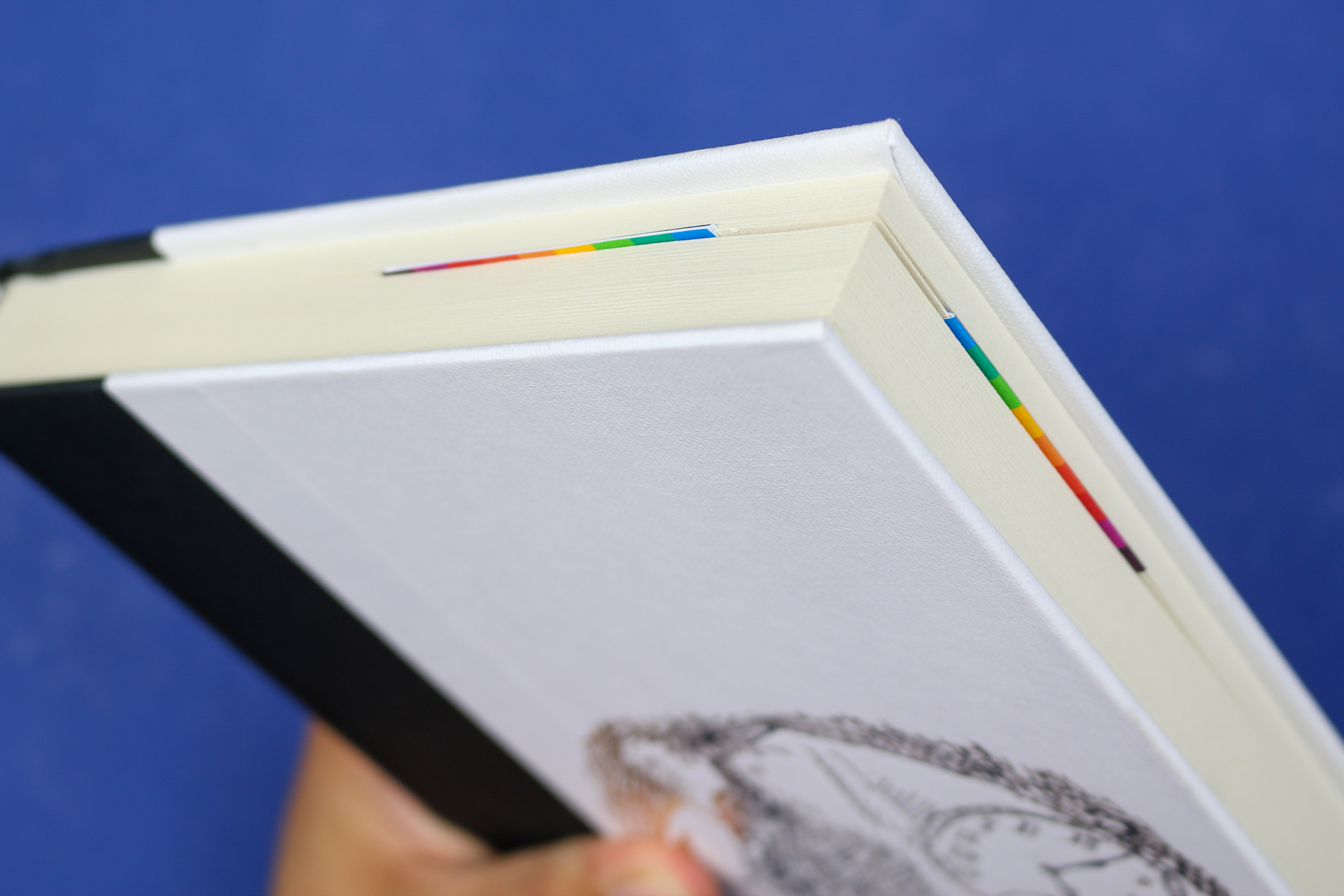 Rainbow Corner bookmark in a white book