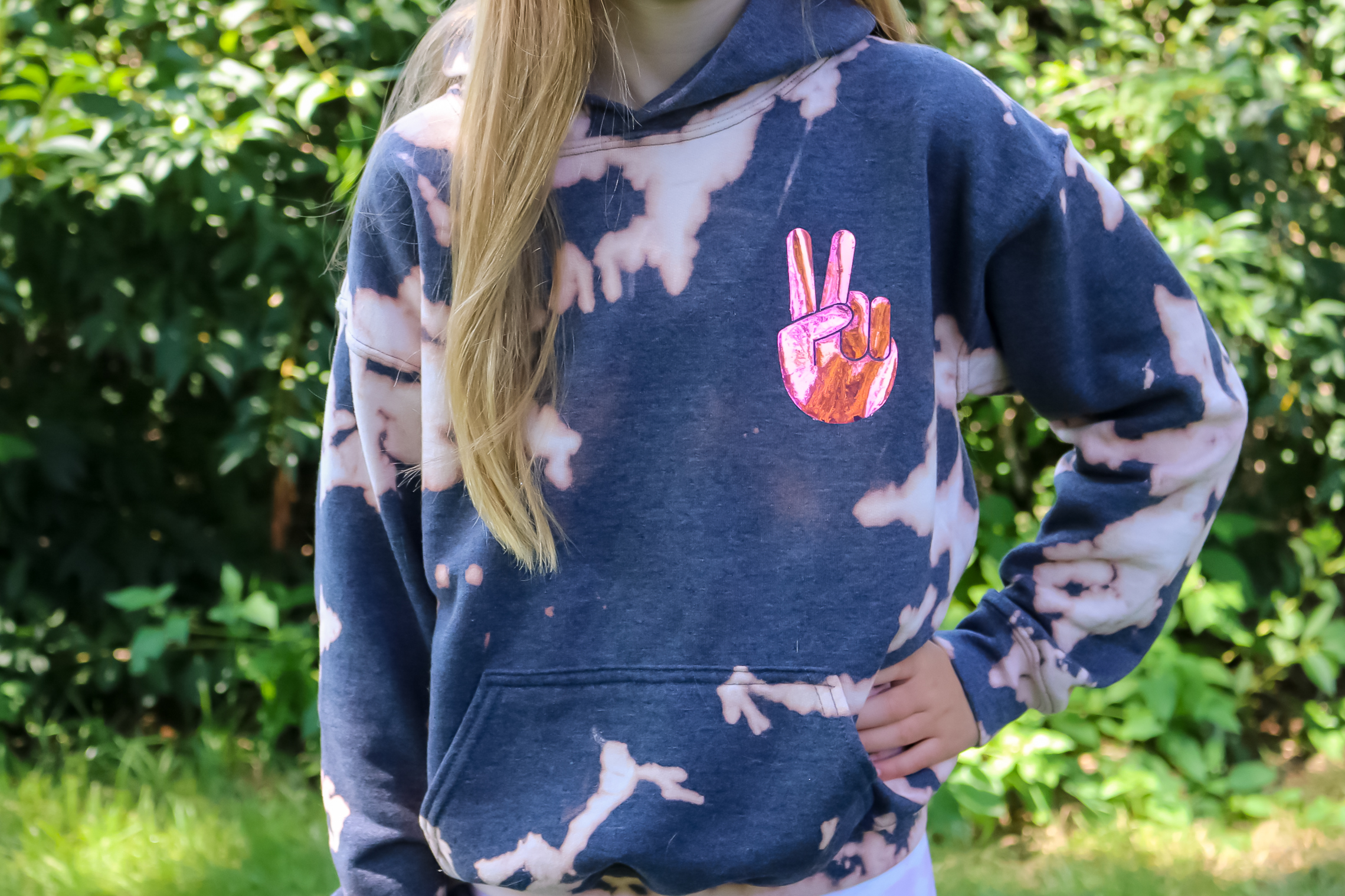 girl wearing bleach dyed sweatshirt with holo vinyl decoration