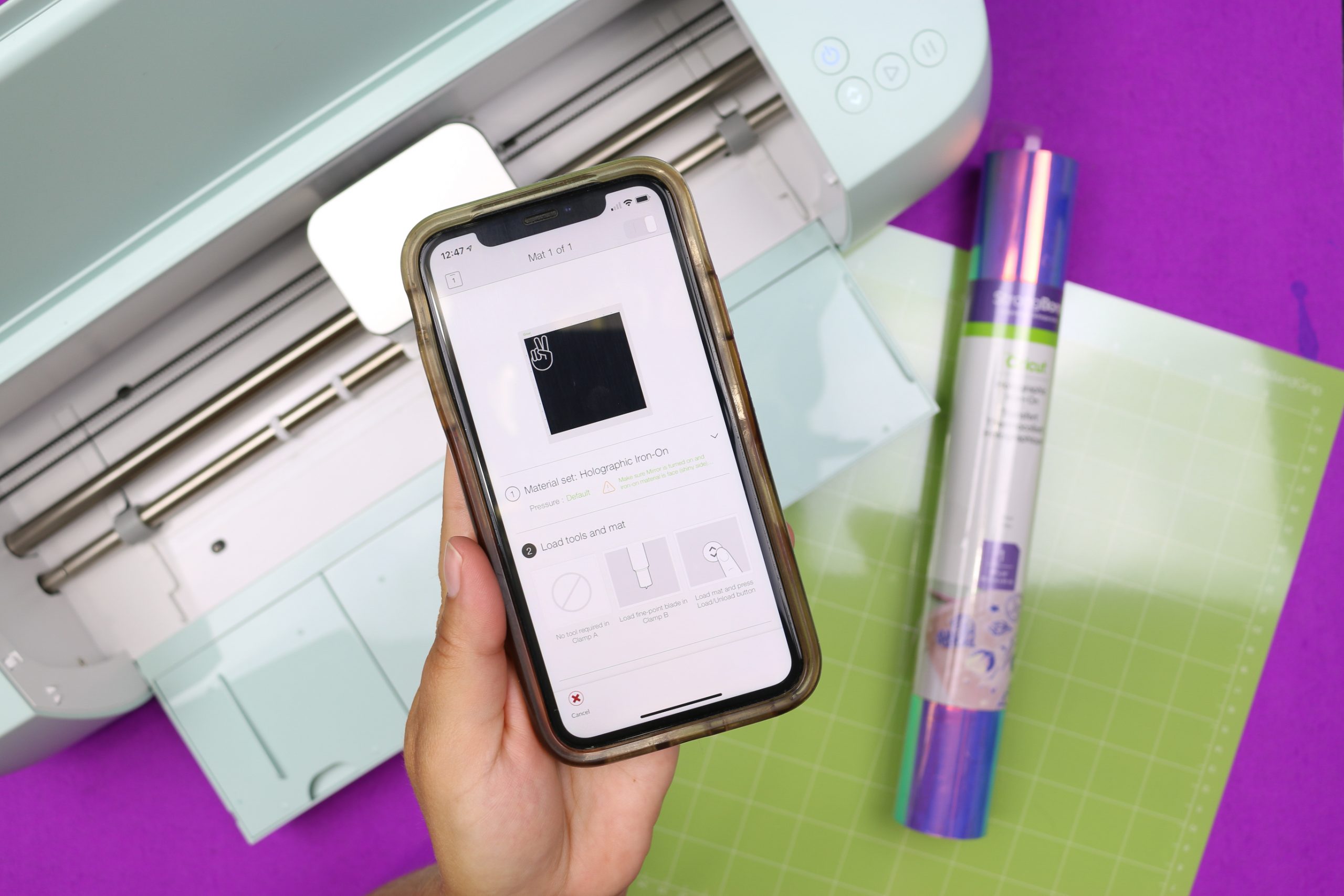 hand holding a smartphone displaying Cricut Design Space