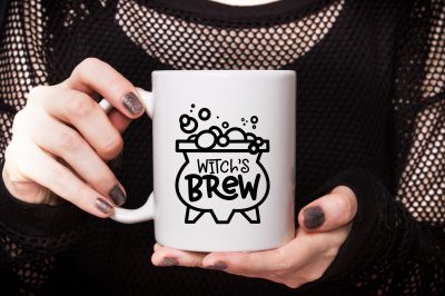 hand holding Witch's Brew mug