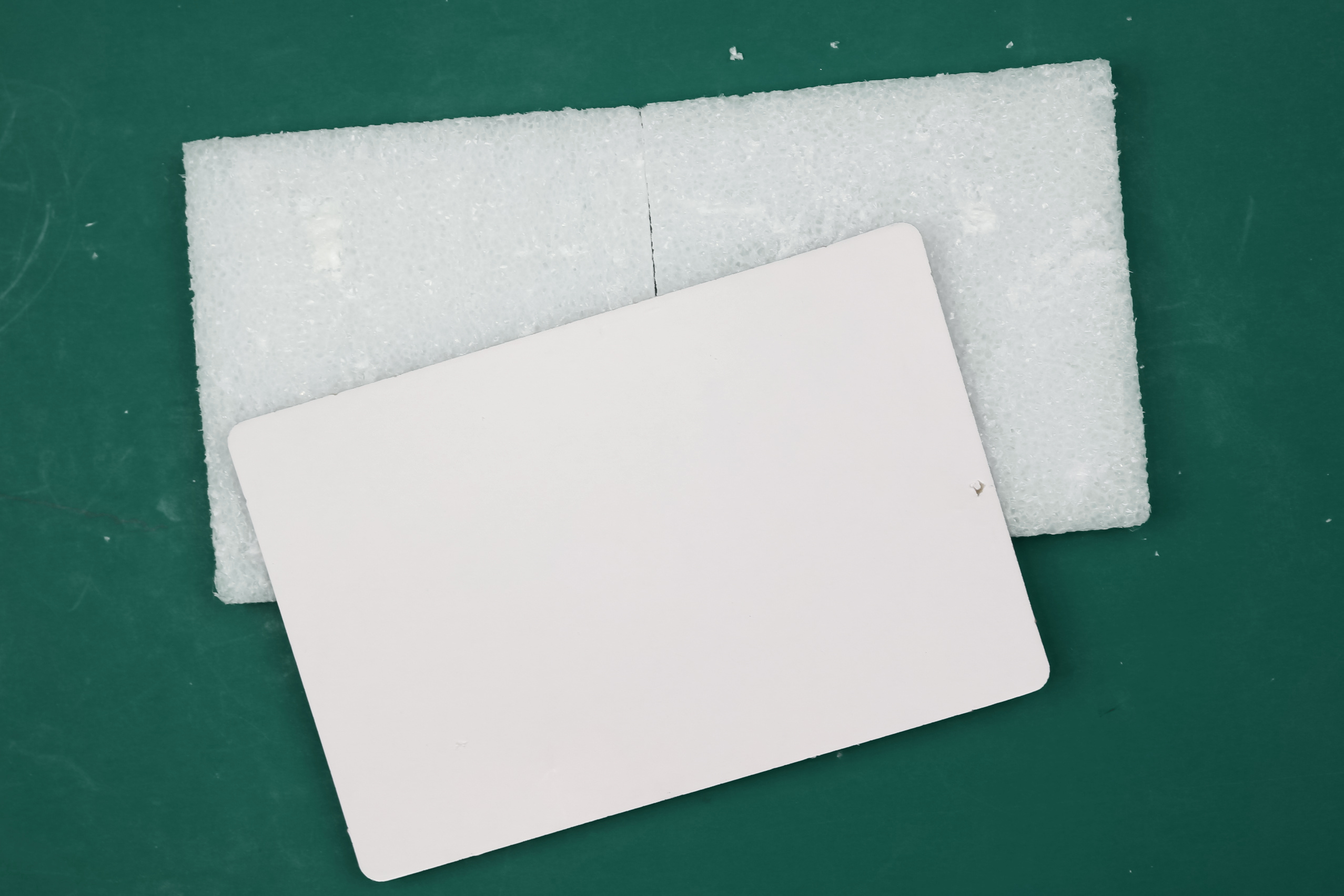 White styrofoam on a green background