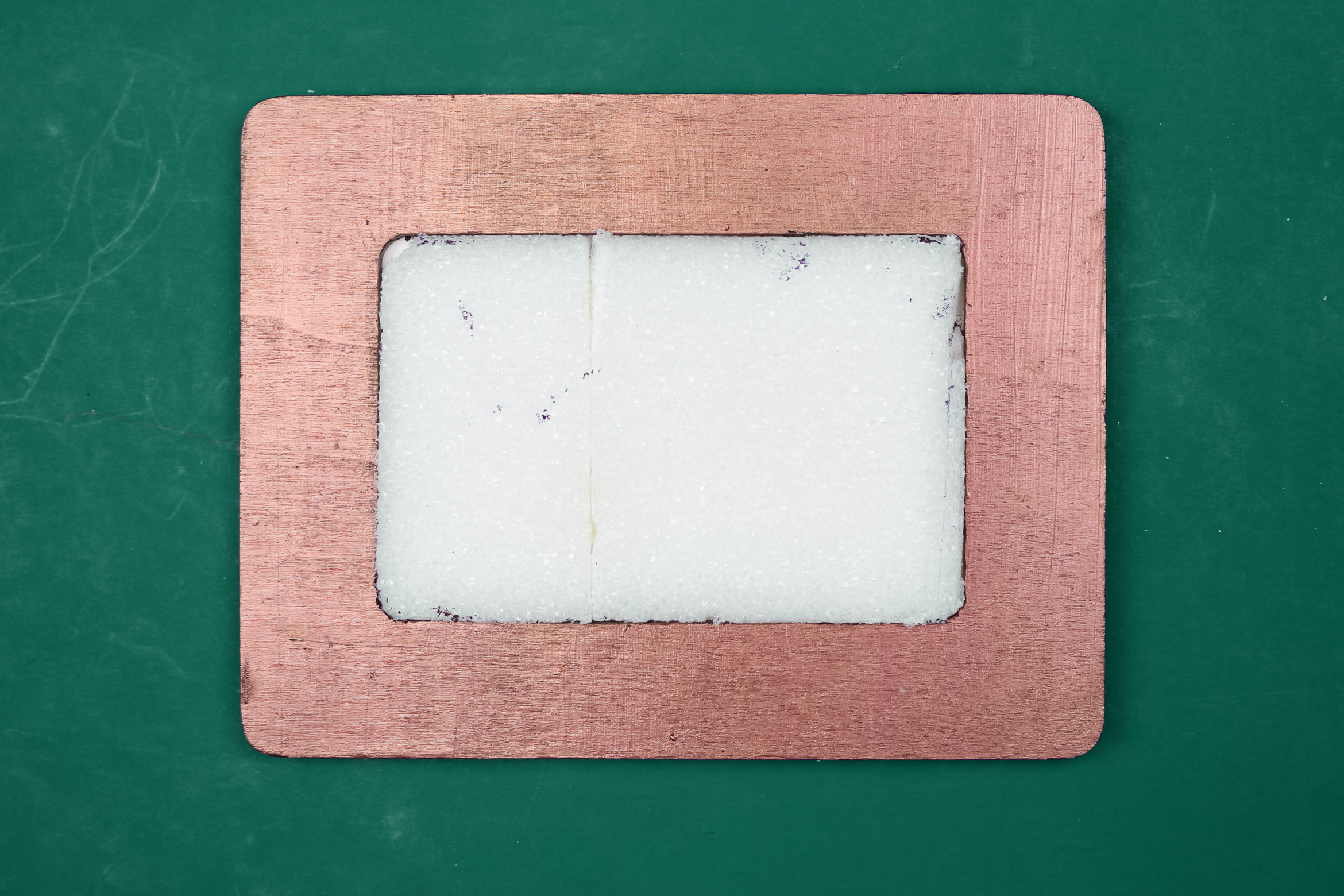 white styrofoam in a copper frame